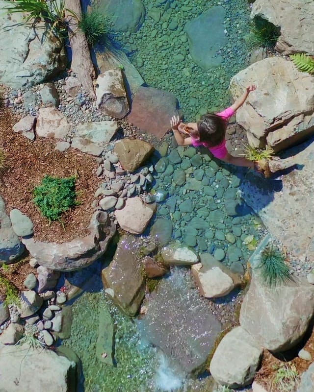 Girl Jumping from stone to stone